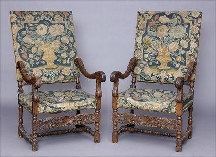 Appraisal: PAIR OF FLEMISH BAROQUE-STYLE CARVED WALNUT ARMCHAIRS Each with needlepoint