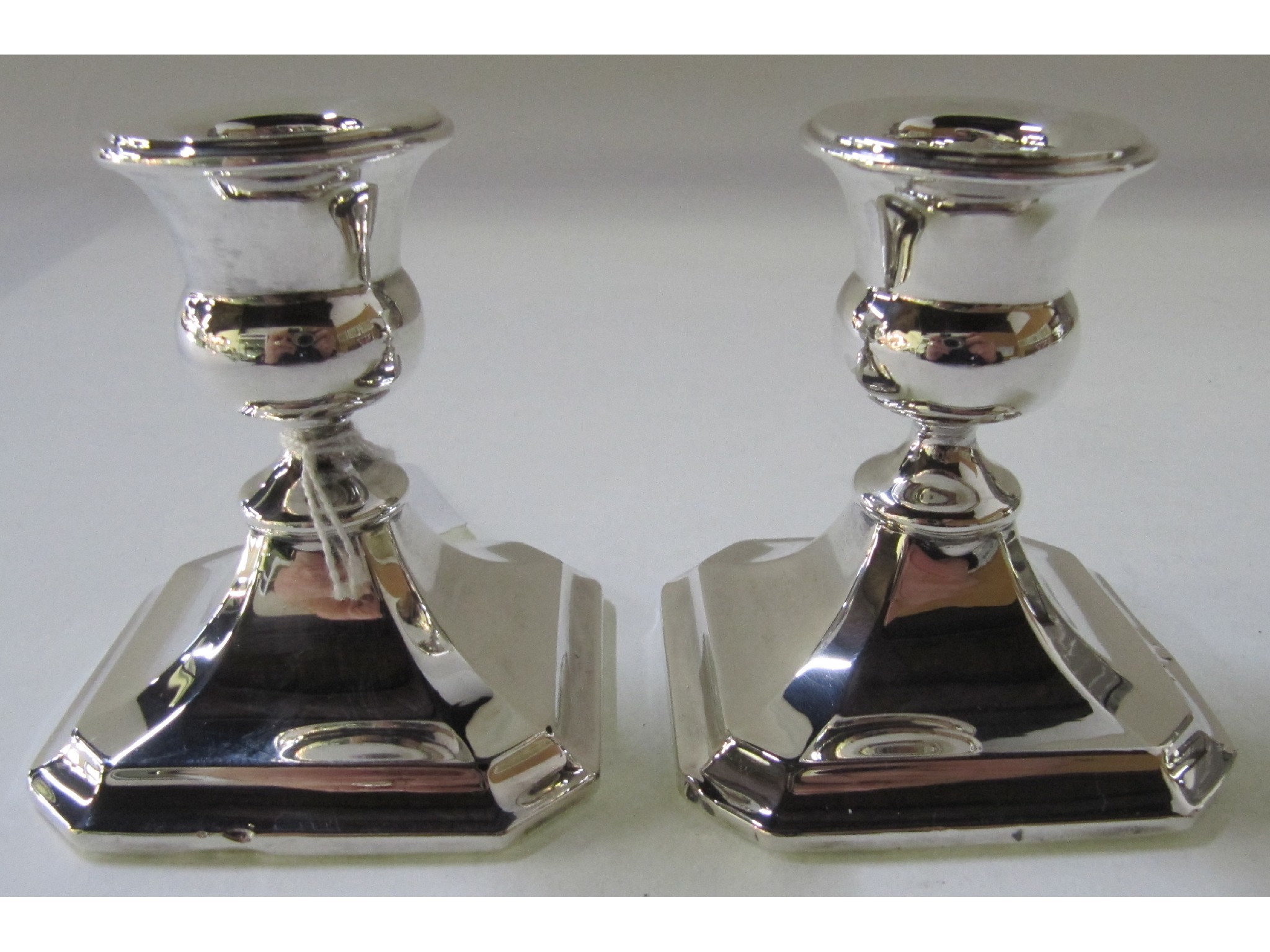 Appraisal: A pair of silver candlesticks Chester