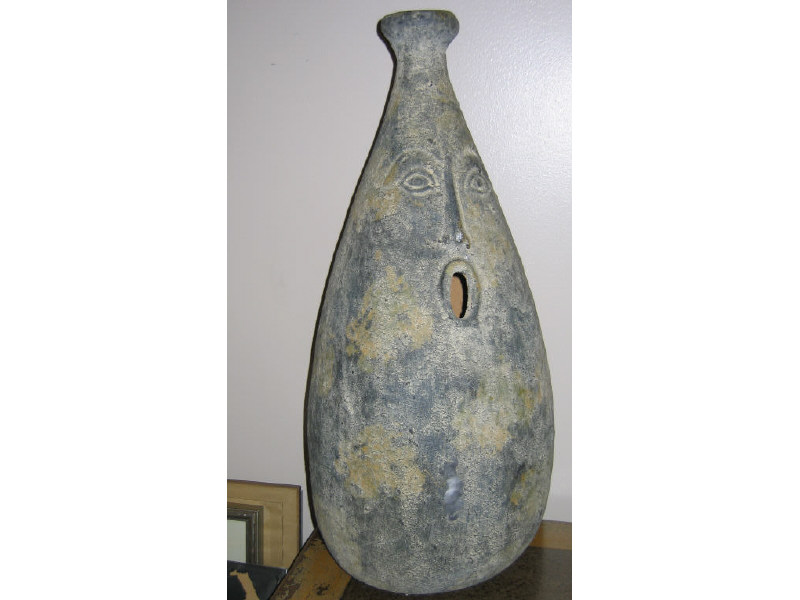 Appraisal: STUDIO CRAFT BOTTLE FORM VESSEL with relief decorated facial expression