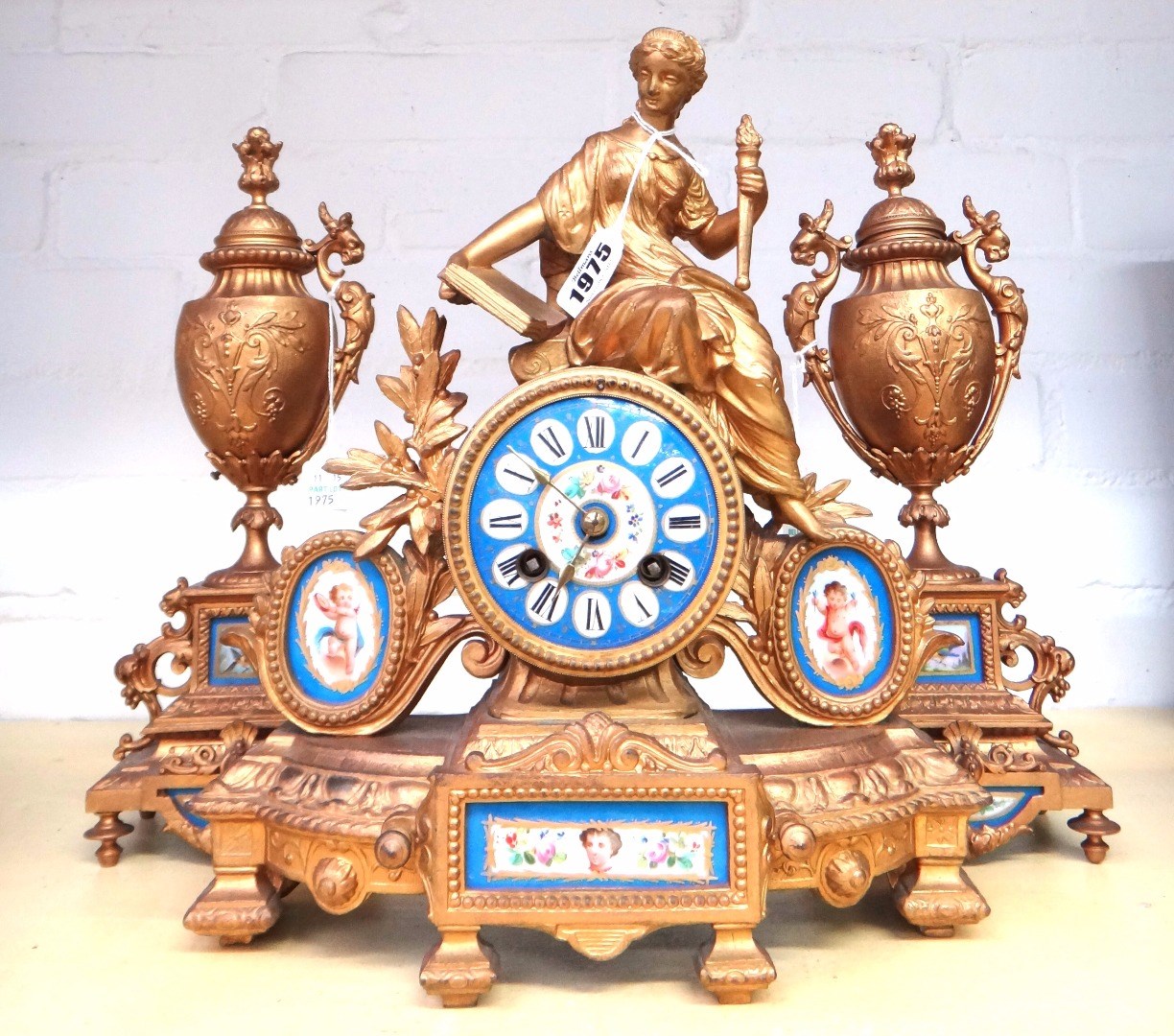 Appraisal: A gilt spelter mantel clock and garniture early th century