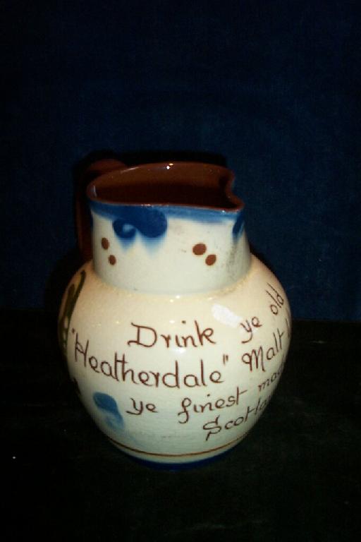 Appraisal: A Torquay ware jug inscribed - Drink Ye Old Heatherdale