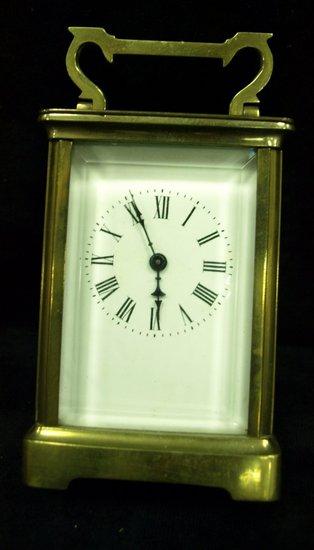 Appraisal: A brass cased carriage clock the enamel dial with Roman