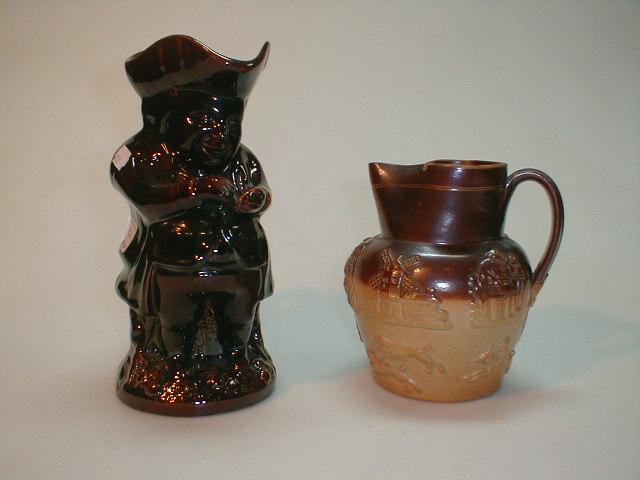 Appraisal: A thC treacle glazed Toby jug modelled as a portly