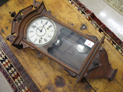 Appraisal: AN EASTLAKE WALNUT CASED WALL CLOCK Waterbury Clock Co c