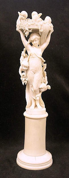 Appraisal: Continental th C ivory figure standing woman holding a basket