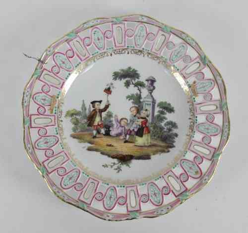 Appraisal: A Meissen plate with pierced border outside decorated children in