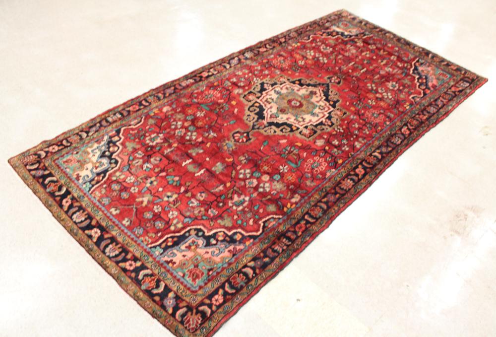 Appraisal: HAND KNOTTED PERSIAN TRIBAL RUG floral and central floral medallion