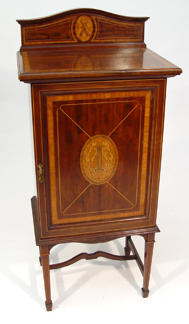 Appraisal: Edwardian mahogany music cabinet the pediment and door crossbanded and