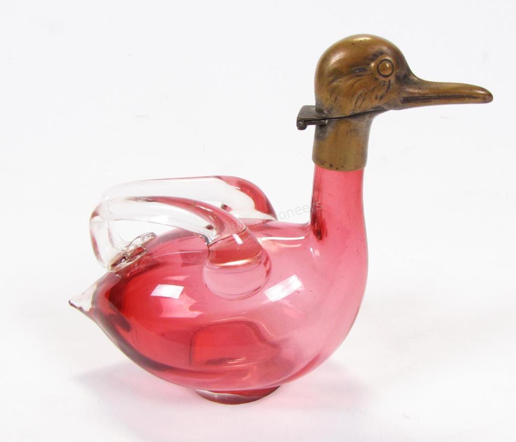 Appraisal: An antique Austrian cranberry glass claret jug with brass duck-head