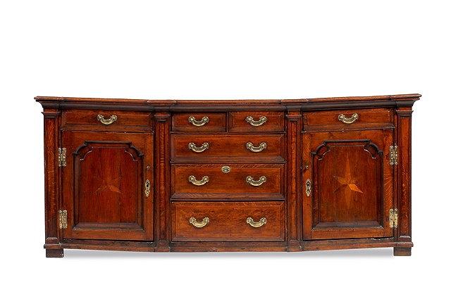 Appraisal: A GEORGE III OAK BREAKFRONT DRESSER BASE with plank top