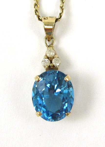 Appraisal: BLUE TOPAZ AND DIAMOND PENDANT NECKLACE suspended on a inch