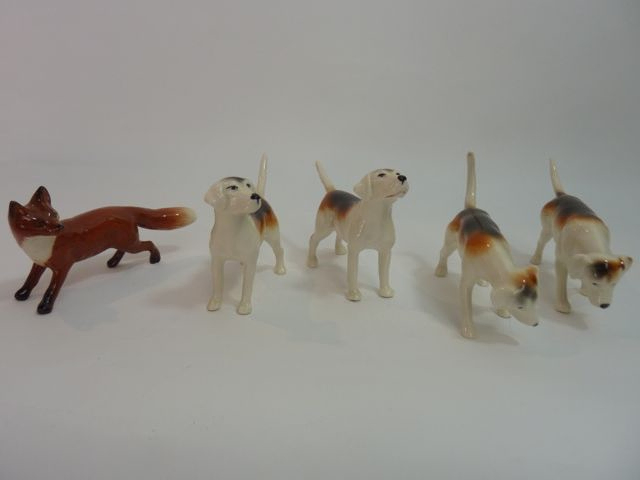 Appraisal: A collection of four Beswick models of hounds in various