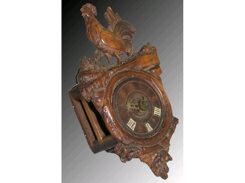 Appraisal: Interesting miniature German wooden clock the dial within a carved