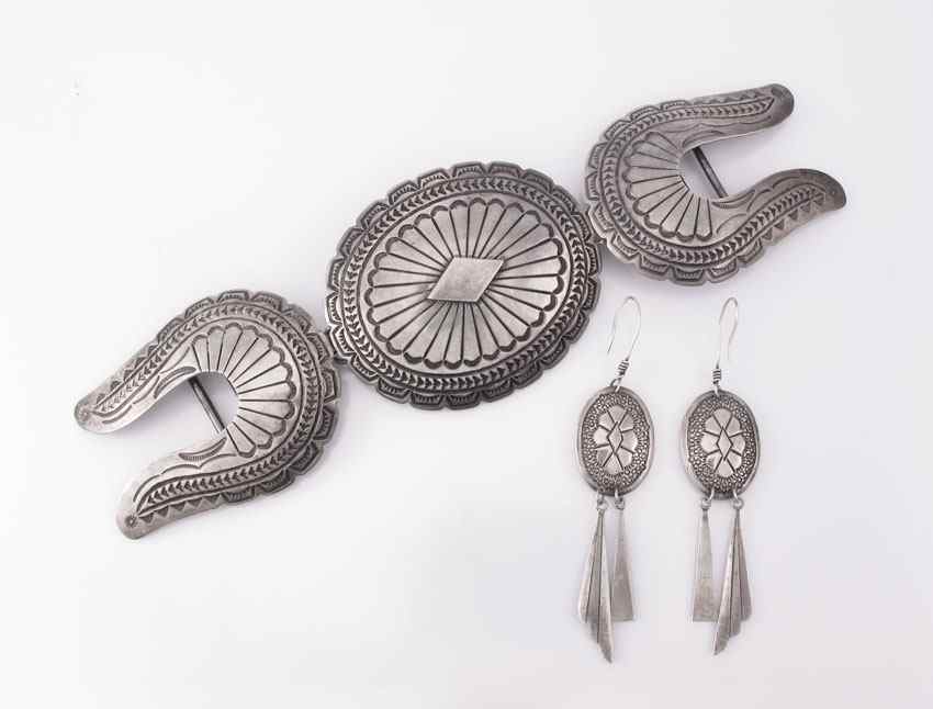 Appraisal: NAVAJO SILVER CONCHO BUCKLES AND EARRINGS An oval stamped buckle