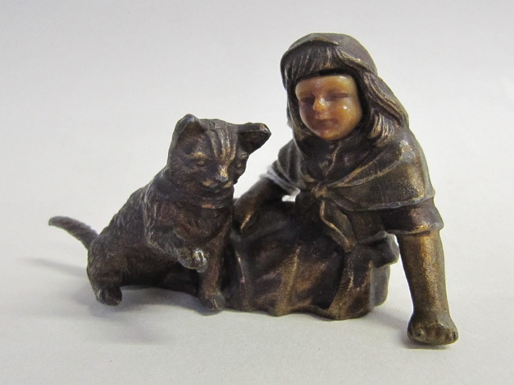 Appraisal: Cast bronzed metal figure group of a girl and cat