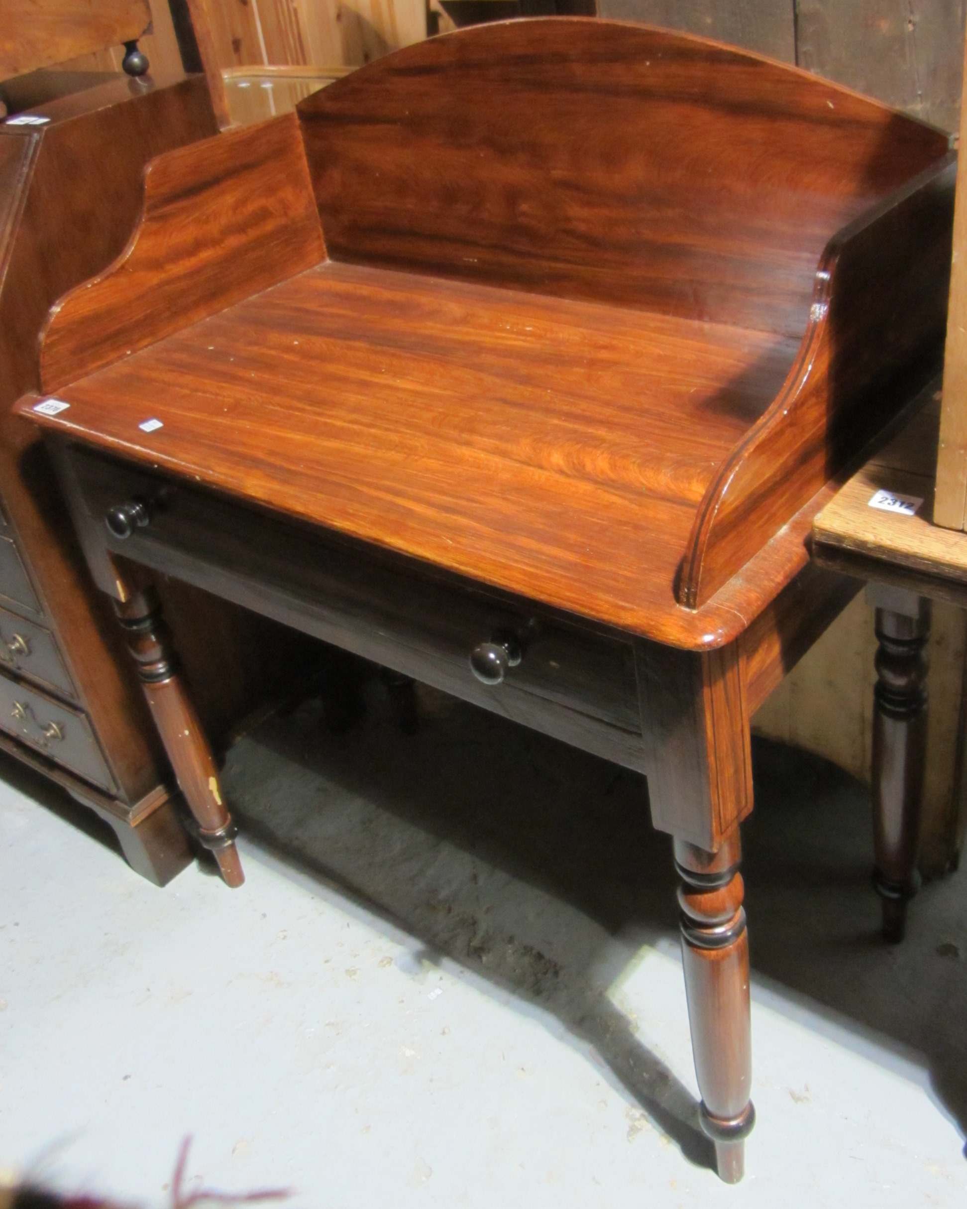 Appraisal: A th century pine faux walnut washstand with three quarter