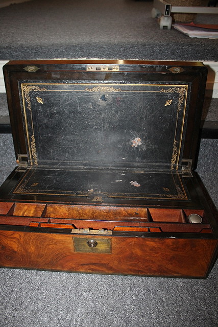 Appraisal: A VICTORIAN WALNUT WRITING SLOPE with brass bindings and fitted