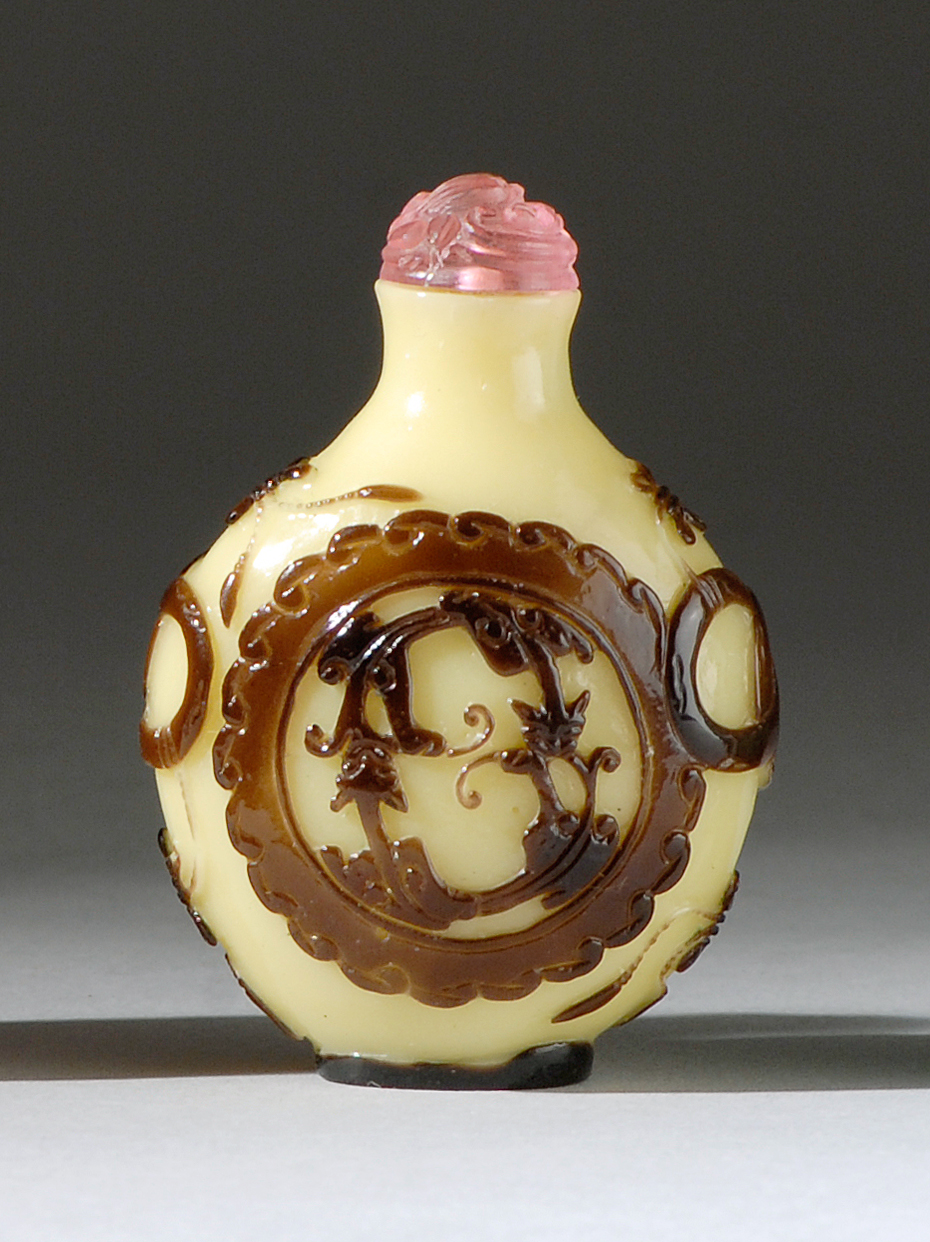 Appraisal: OVERLAY GLASS SNUFF BOTTLE With aubergine dragon medallion design on