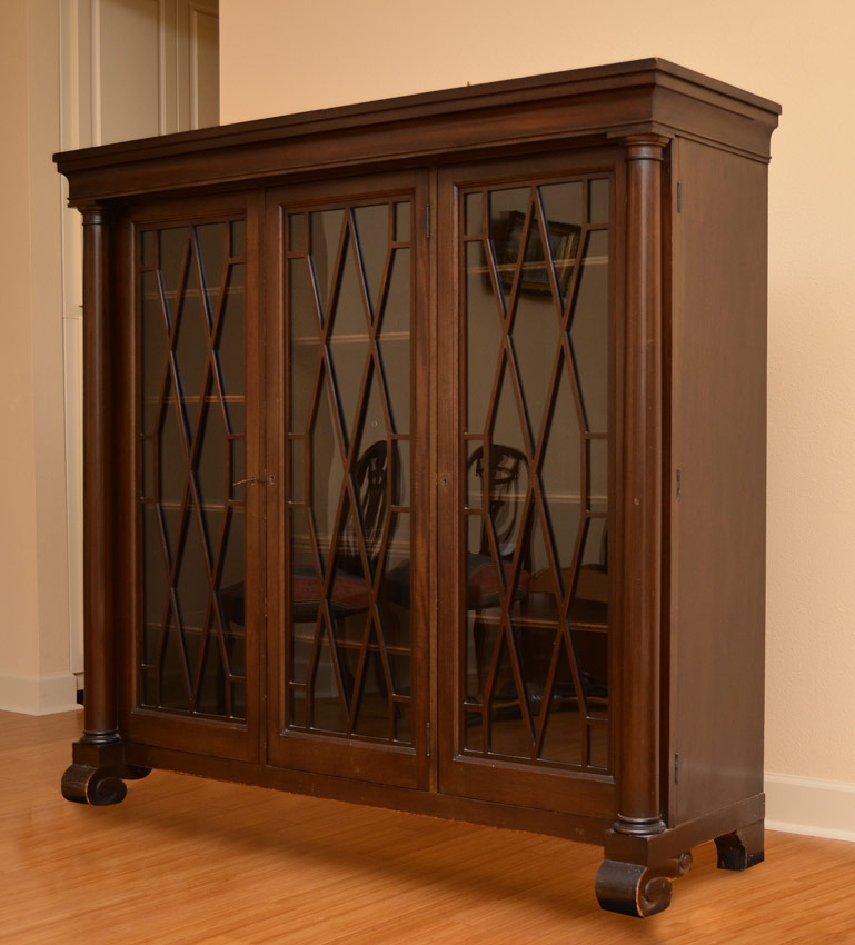 Appraisal: DOOR WALNUT BOOKCASE glass doors with fretwork adjustable interior shelves