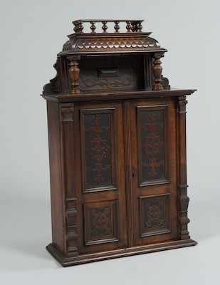 Appraisal: A Continental Ornamental Wood Cabinet The dark glossy wood two-door