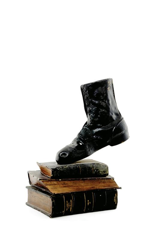 Appraisal: Folk art sculpture comical view depicting boot above stack of