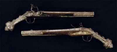 Appraisal: A pair of Turkish flintlock pistols with engraved steel and