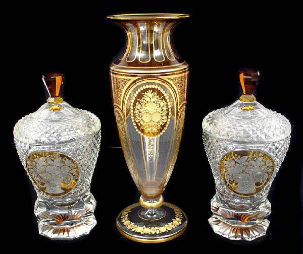 Appraisal: Two Bohemian cut glass covered urns together with a similarly