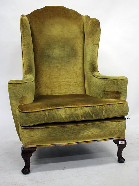 Appraisal: AN TH CENTURY STYLE OAK AND UPHOLSTERED WING ARM CHAIR