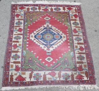 Appraisal: Caucasian Carpet Having a red central medallion on green field