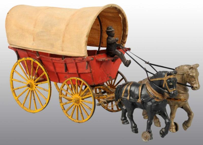 Appraisal: Cast Iron Hubley Horse-Drawn Covered Wagon Toy Description Pulled by