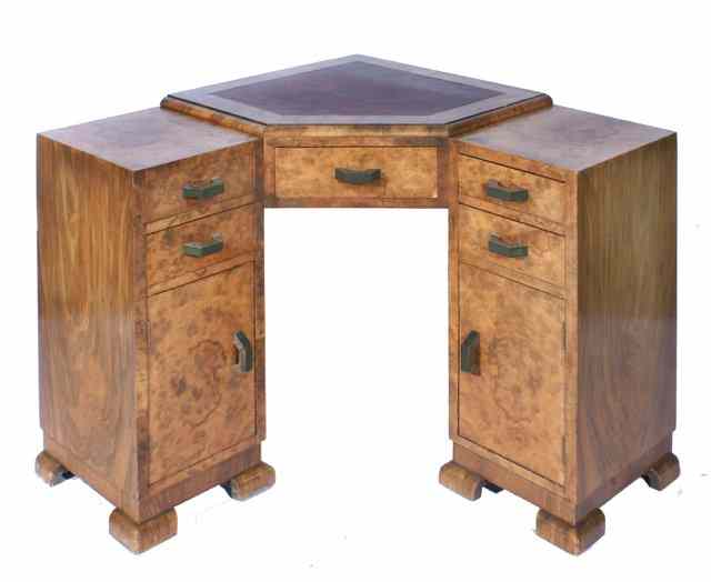 Appraisal: AN ART DECO WALNUT CORNER DESK with red leatherette inset