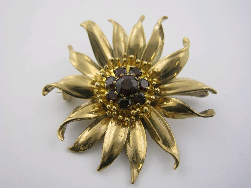 Appraisal: An Edelweiss Brooch the centre claw-set eight circular-cut garnets approx