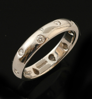 Appraisal: A Tiffany Co diamond band The platinum band bezel set