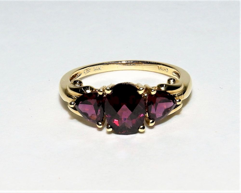 Appraisal: K Yellow Gold Three Stone Garnet Ring Contemporary Central oval