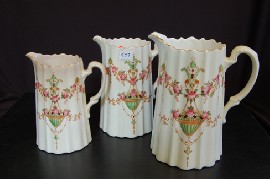 Appraisal: THREE GRADUATED CROWN DEVON PORCELAIN JUGS