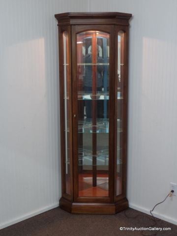 Appraisal: American Lighted Mahogany Corner Curio Cabinet Produced by American Furniture