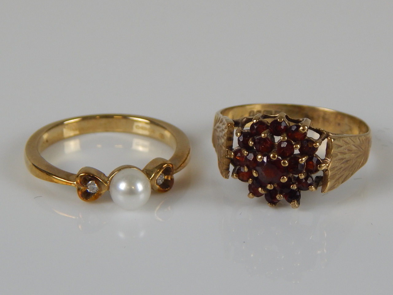 Appraisal: Two dress rings a garnet set ring and a pearl