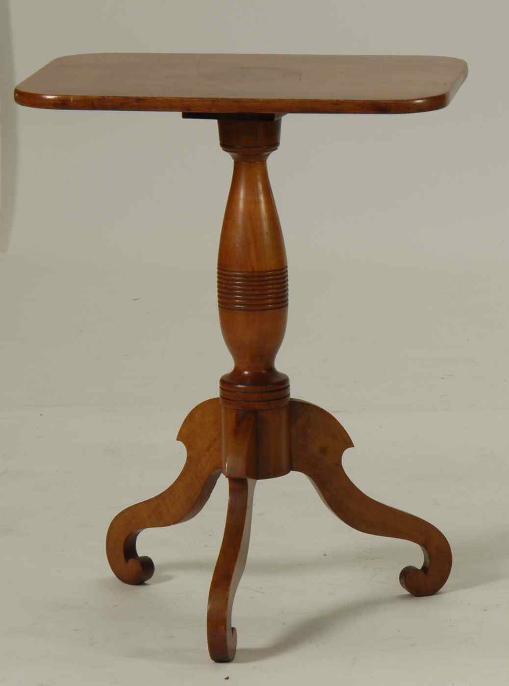 Appraisal: ANTIQUE AMERICAN CANDLESTAND th CenturyIn cherry Rectangular top with molded