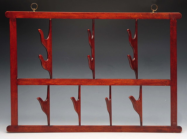 Appraisal: A MAHOGANY RIDING WHIP RACK of rectangular form with brass