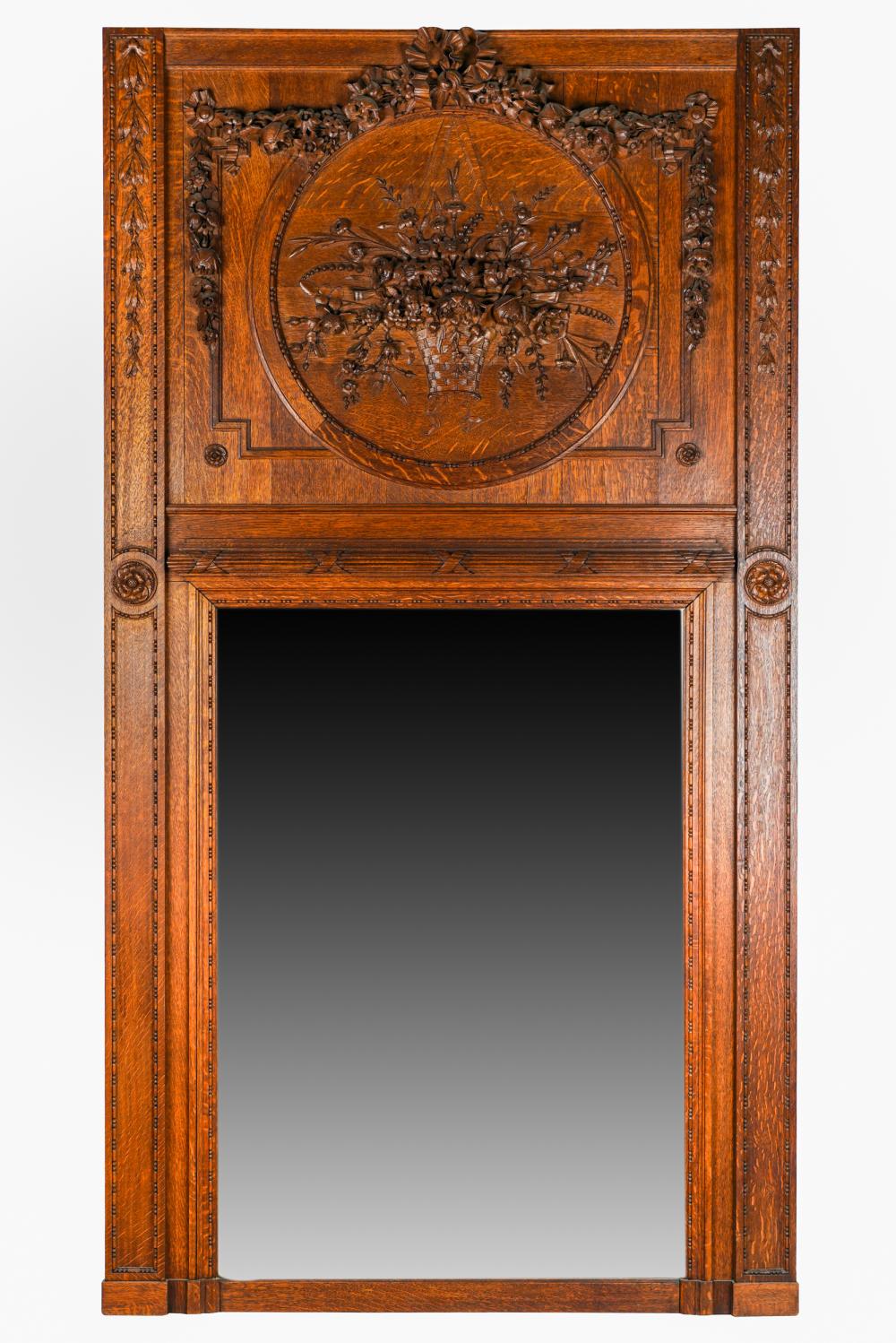 Appraisal: FRENCH OAK TRUMEAU MIRRORthe upper panel carved with a floral