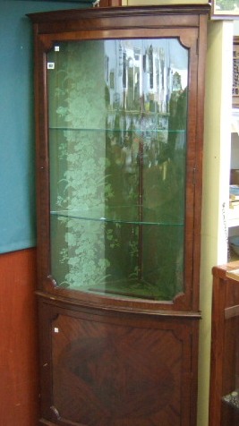 Appraisal: An Edwardian mahogany floor standing bowfront display cabinet cupboard the