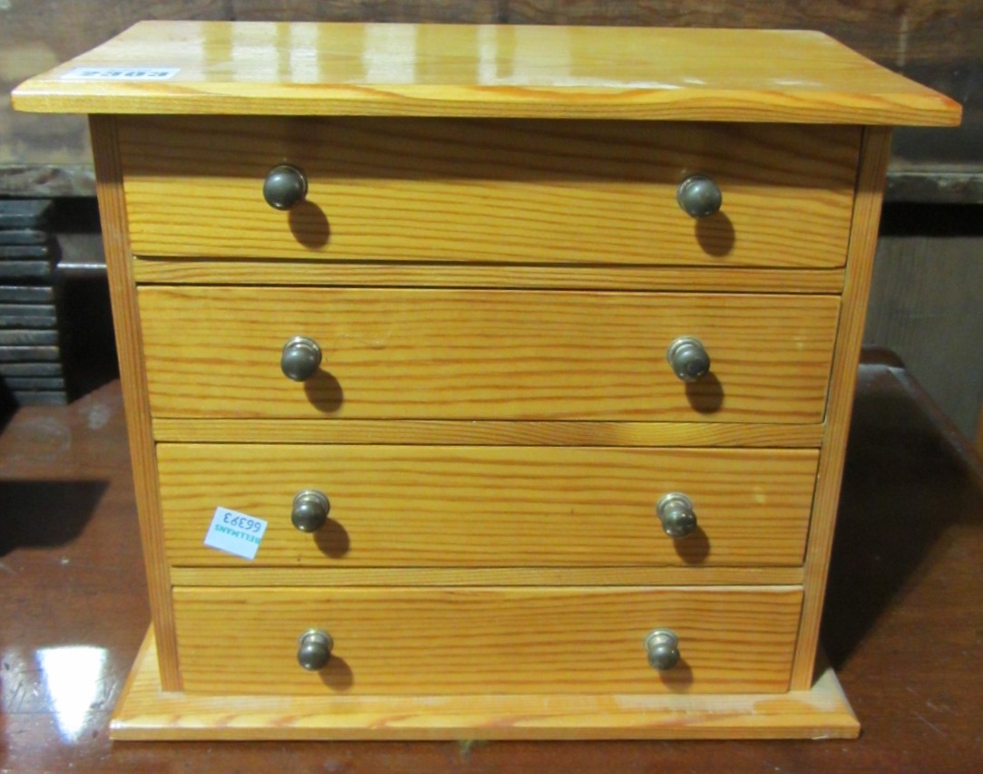 Appraisal: A miniature pine four drawer chest a convex wall mirror