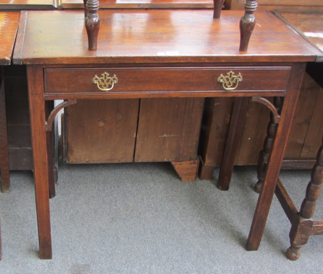 Appraisal: An th century stained pine single drawer side table on