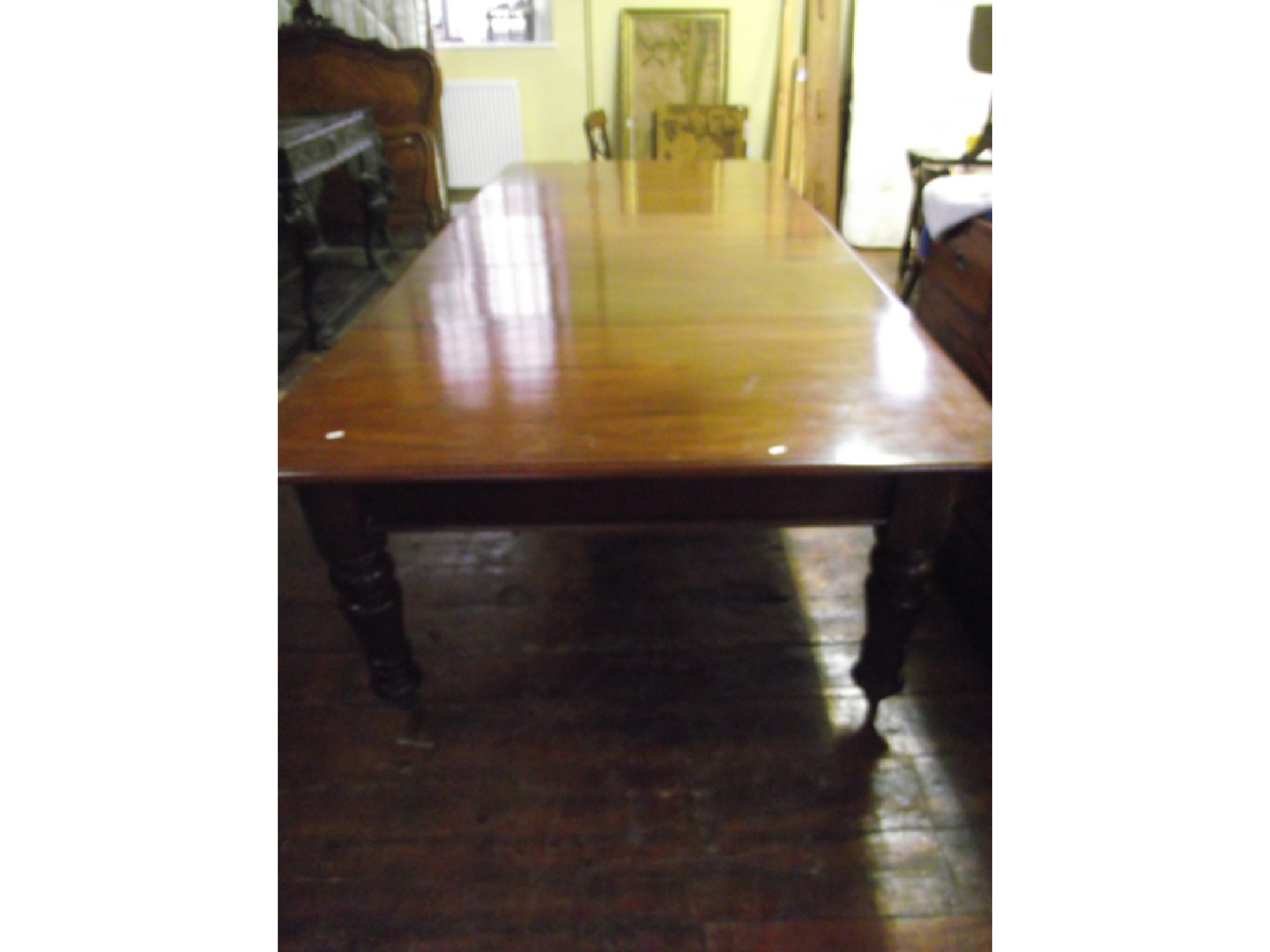 Appraisal: A substantial Victorian mahogany extending dining table with three additional