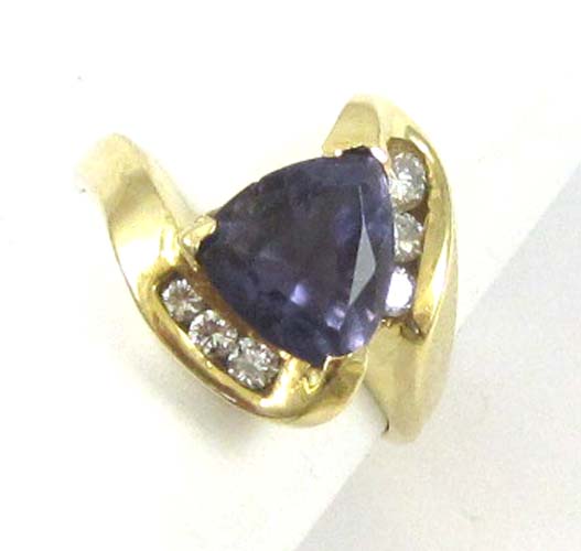 Appraisal: TANZANITE DIAMOND AND FOURTEEN KARAT GOLD RING with three round-cut