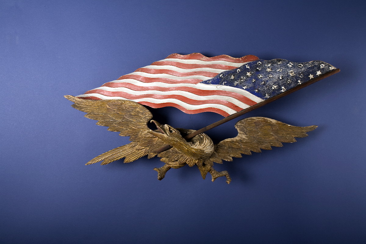 Appraisal: CARVED AND PAINTED PATRIOTIC EAGLE WITH AMERICAN FLAG ATTRIBUTED TO