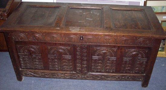 Appraisal: An th Century oak chest the triple panel lid above