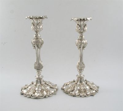 Appraisal: A pair of Victorian cast plated candlesticks on shaped circular