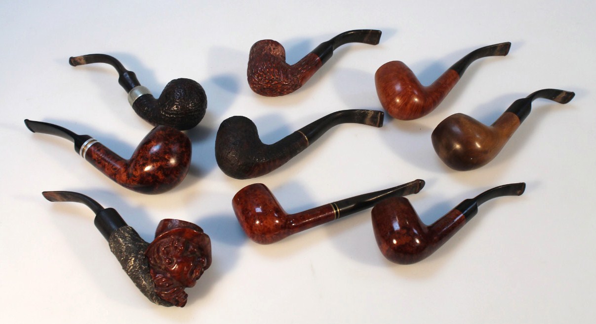 Appraisal: Various bygone pipes to include one carved with a figure