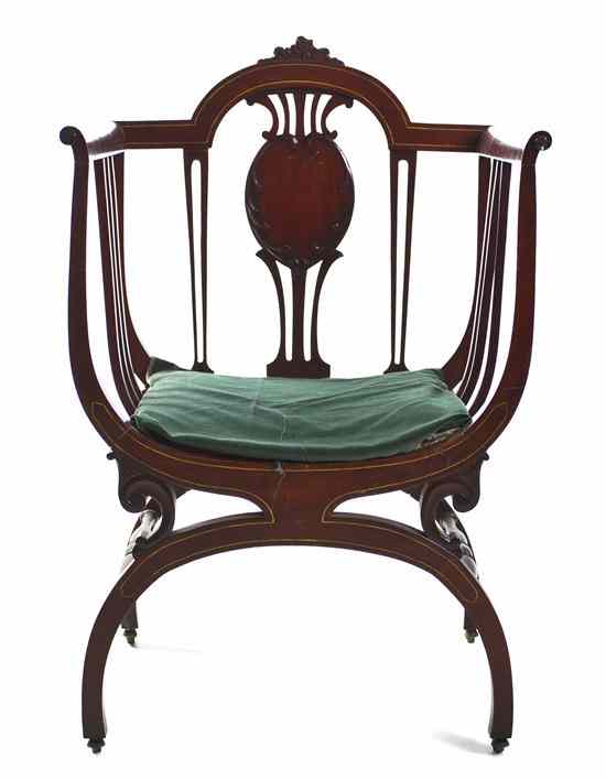 Appraisal: An Edwardian Mahogany Open Armchair the shaped crest rail over